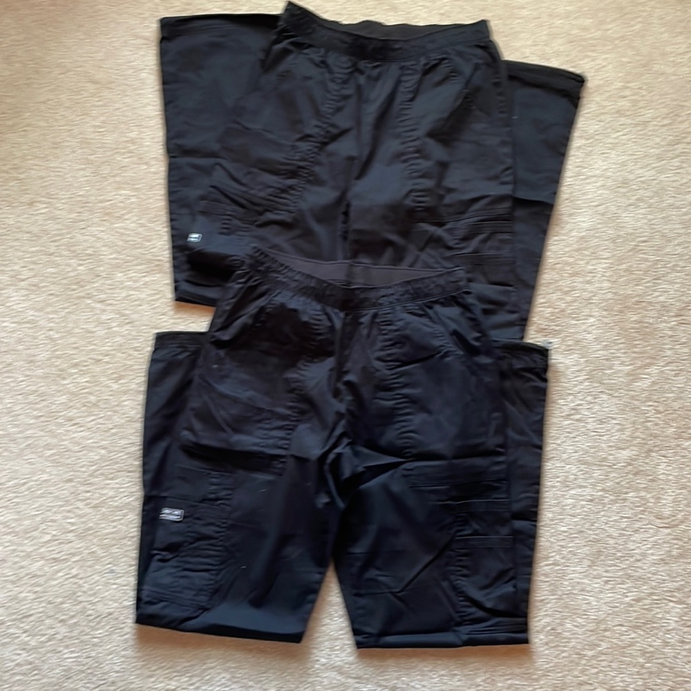Four pairs of black Cherokee scrubs worn but in good condition